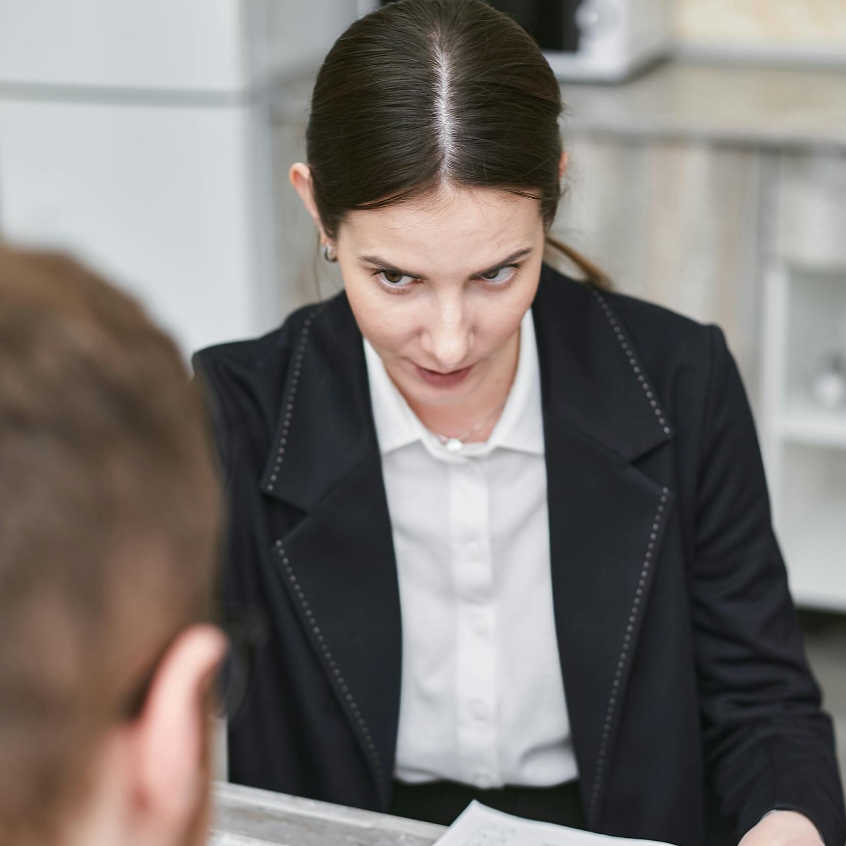 Professional business meeting with a female executive reviewing a contract with a client.